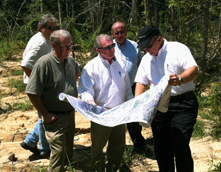 A group engineers and state and city employees look at restoration plans in the Joe's Branch watershed in Alabama.