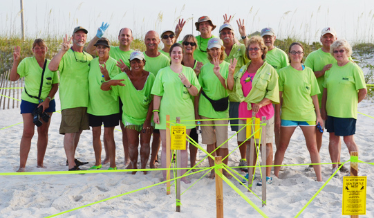 A few of the dedicated Share the Beach volunteers celebrate finding their third sea turtle nest of the 2014 season.